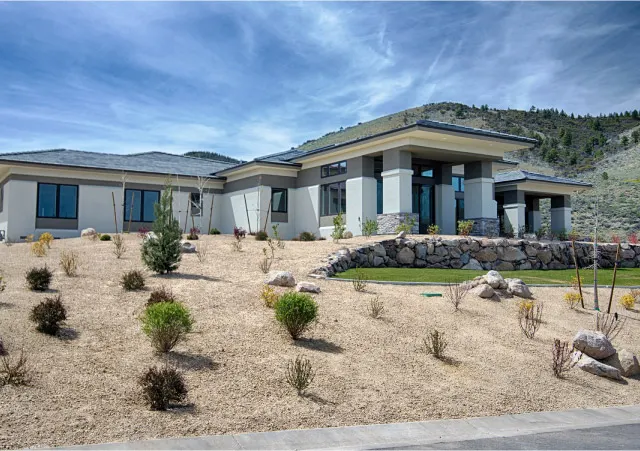 Completed modern C&E Builders home set against the Nevada hills